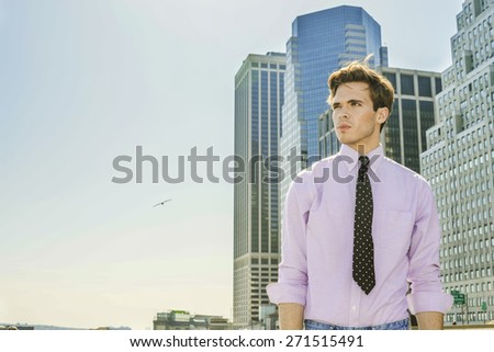 Man Power. Young blonde, handsome businessman, wearing long sleeve, pink shirt, necktie, standing in the front of busy business district, confidently looking forward. Instagram filtered effect.
