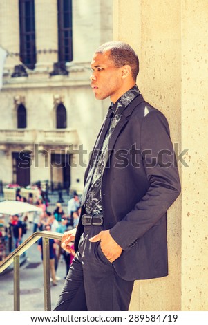 Serious African American businessman with scar on his head, standing on street in New York, thinking. Concept of facing tough reality, up and down, self assured, self esteem, confidence and success.