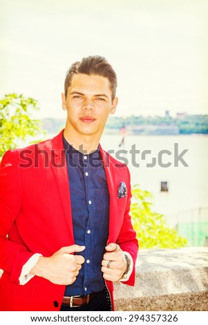 Businessman traveling in New York. Dressing in red blazer, blue collarless under shirt, pocket square, a young college student standing by Hudson River, confidently looking forward. Instagram effect.