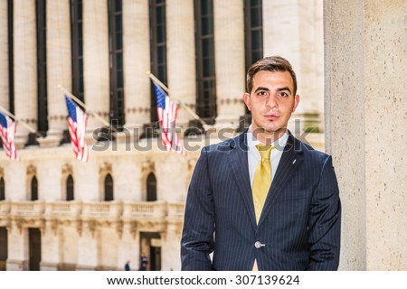 Businessman with little scar on lip - cleft lip, dressing in blue suit, yellow tie, standing outside office. Concept of facing reality, up and down, self assured, self esteem, confidence and success.