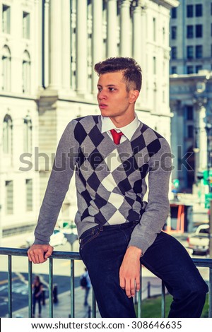American College Student Studying in New York. Wearing black, white, gray patterned sweater, jeans, a young college student sitting on railing on campus, relaxing, thinking, Instagram filtered look.