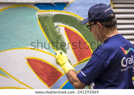 SAO PAULO, BRAZIL, December 03, 2014: task force paints the wall in Sao Paulo, Brazil