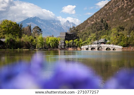 Lijiang old town scene-Black Dragon Pool Park. Jade Dragon Snow Mountain in the background.