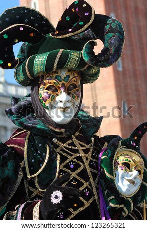 VENICE - FEBRUARY 17: Funny gaze on the green joker mask during Carnival on February 17 , 2012 in Venice , Italy . Carnivals significance declined through to the 1930, when Mussolini banned it.