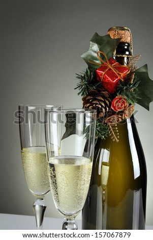 Detail of Christmas glasses and a bottle of champagne . Holiday and New years eve