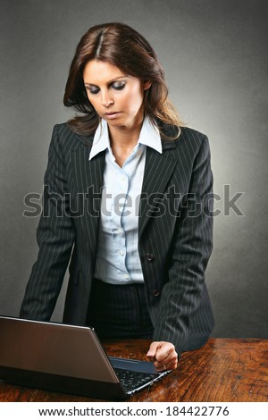Attractive manager woman angry with the computer . Business and technology