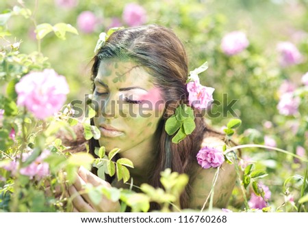 Girl standing in rose field
