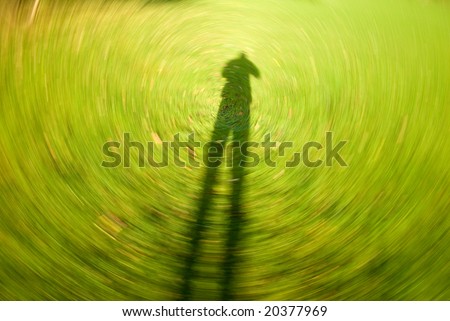 A background depicting a human shadow as the world spins past.