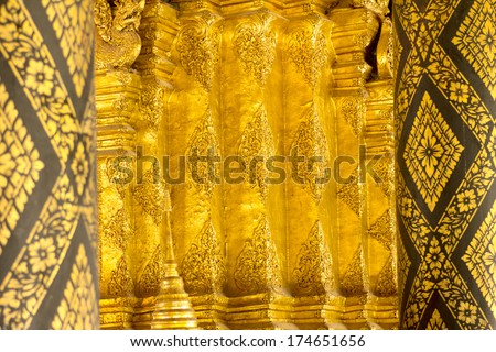 Gold black-ground black pole in the thai temple art