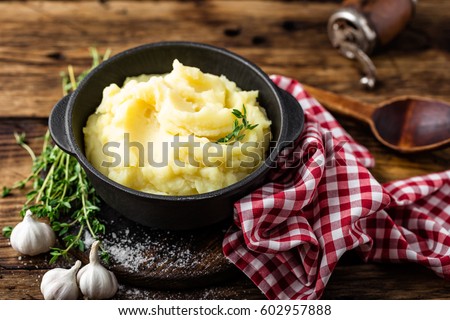 Mashed potatoes, boiled puree in cast iron pot on dark wooden rustic background Stock foto © 