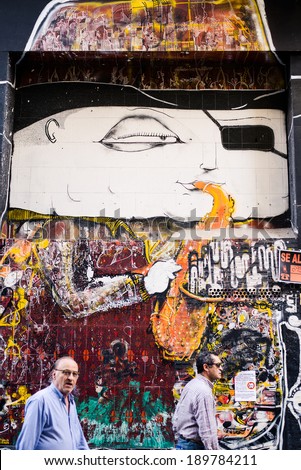 Madrid, Spain Ã¢Â?Â? April 10 2014: Street art with people passing by on the street.
