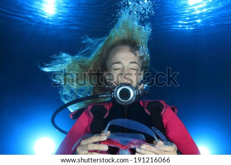 Female scuba diver underwater without mask