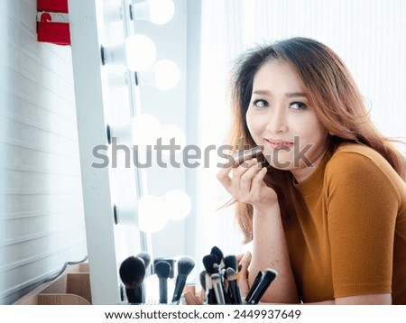 Similar – Image, Stock Photo Woman applying lipstick near car mirror