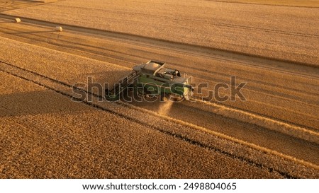 Image, Stock Photo Combine harvester of an agricultural machine collects ripe golden wheat on the field. Drone Shot. copyspace for your individual text