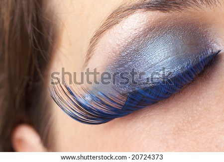Macro shot of beautiful eyes with bright blue make-up and fake eyelashes. Not a crop. Shallow depth of field