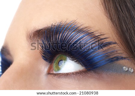 Macro shot of beautiful green eyes with bright blue make-up and fake eyelashes. Not a crop. Shallow depth of field