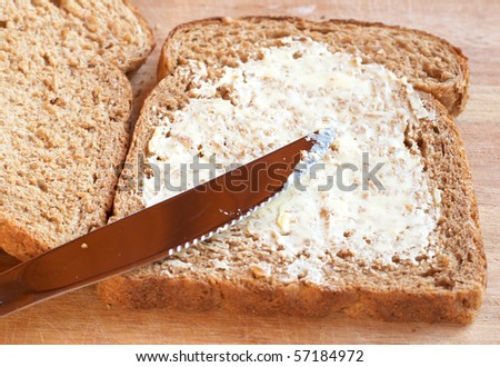 Two slices of Tasty healthy wholewheat bread with butter spread