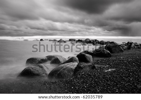 Dramatic landscape with rock coast and bad weather clouds in sky