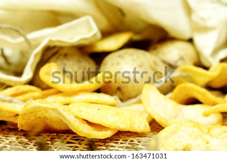 Natural potato chips in a package and potatoes in the bag