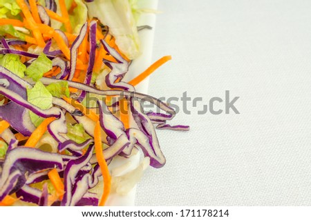 Salad with fresh vegetables on a white porcelain plate