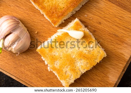 Piece of toasted bread with garlic top view