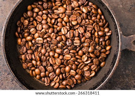 Coffee beans during cooking on the stove top view