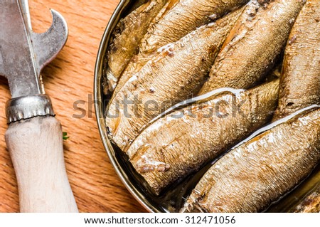 Canned sardines closeup top with can opener