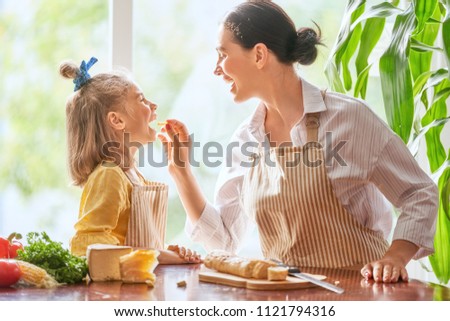 Similar – Image, Stock Photo Smiling woman cutting cheese for salad in kitchen