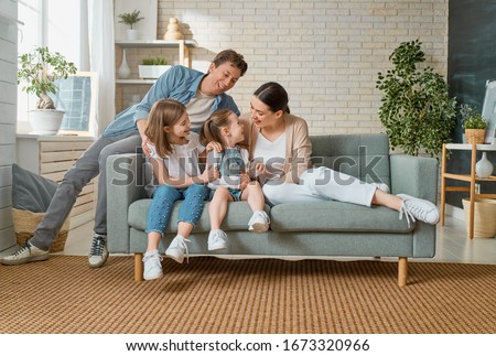 Happy family! Two children daughters with mother and father. Mum, dad and girls laughing and hugging.                                