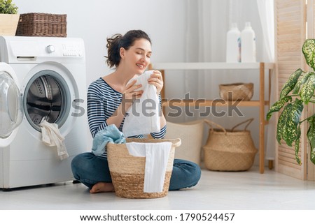 Similar – Image, Stock Photo Mother doing the laundry together with her young child