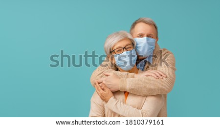 Similar – Image, Stock Photo Senior couple wearing protective face masks outdoors