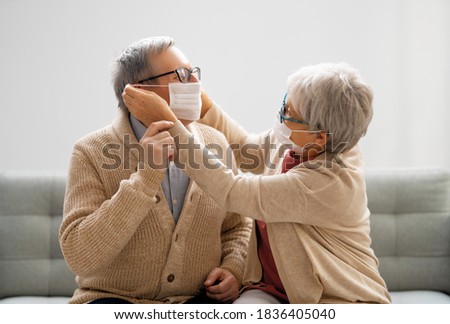 Similar – Image, Stock Photo Senior couple wearing protective face masks outdoors