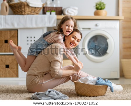 Similar – Image, Stock Photo Mother doing the laundry together with her young child