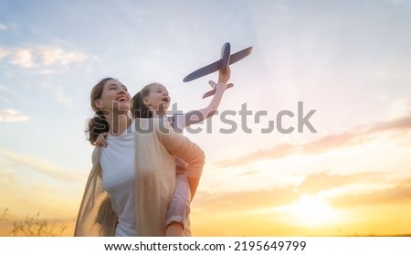 Similar – Image, Stock Photo Young mother walking with her little daughter in the green field. Family holiday in garden. Portrait mom with child together on nature. Mum, little daughter outdoors. Happy Mothers Day. Close up.