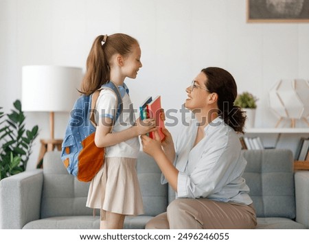 Image, Stock Photo A young girl is sitting in a chair and exchanging messages online on her phone. Home recreation, modern lifestyle