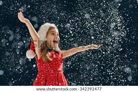 Similar – Image, Stock Photo A little girl catches soap bubbles in the park, sitting on the grass. The concept of a happy childhood