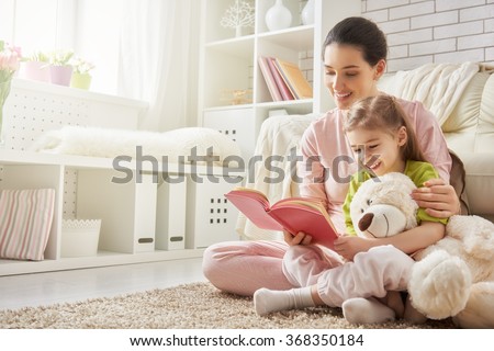 Similar – Image, Stock Photo Mother reading book her daughter in bed before going to sleep. Bedtime stories for child