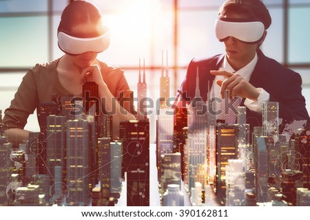 two business persons are developing a project using virtual reality goggles. the concept of technologies of the future 商業照片 © 