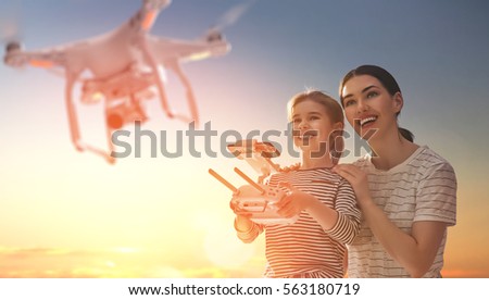 Similar – Image, Stock Photo Little kid operating drone in field