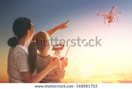 Similar – Image, Stock Photo Little kid operating drone in field