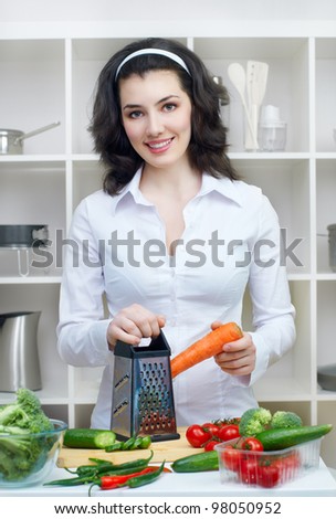 woman in kitchen making salad