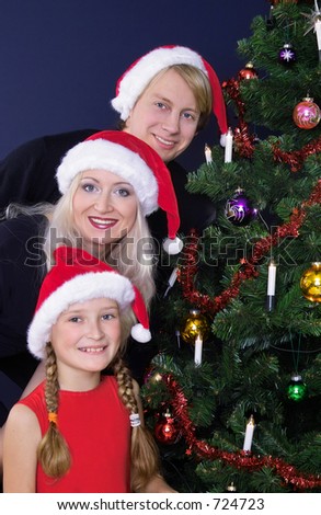 happy family at the christmas tree
