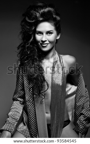 Photo of attractive smiling beautiful woman with magnificent hair and sweet smile posing on dark background