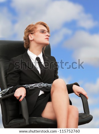 Out of office - working woman chained to her armchair (blue sky background)