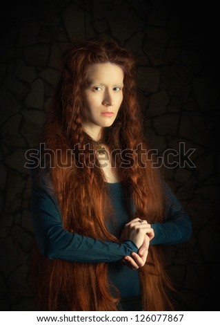 Portrait of young woman with long red hair. Image stylized as old picture