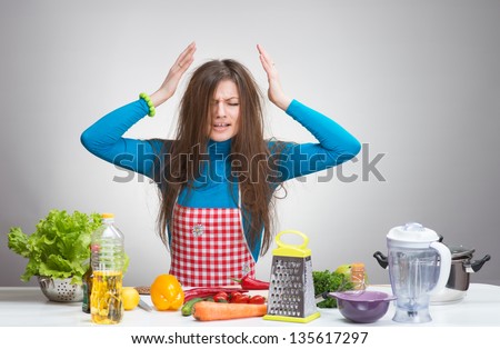 Portrait of a stressed housewife in the kitchen
