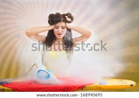 Funny portrait of a woman looking at the hot flat iron, rays background