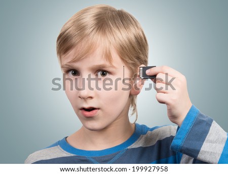 Boy inserting SD card into his head