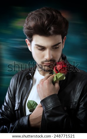 Handsome man with a single red rose