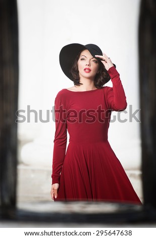 Portrait of a lady in the red dress and big black hat
